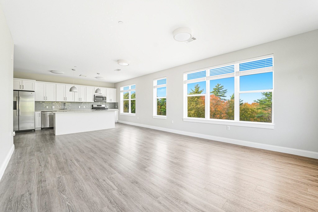 A spacious kitchen with a large island and stainless steel appliances.