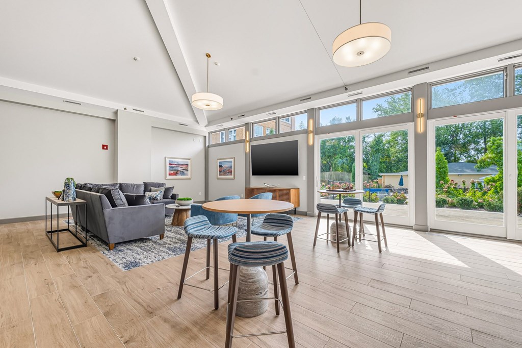 A living room with a grey couch, a wooden table, and a television.