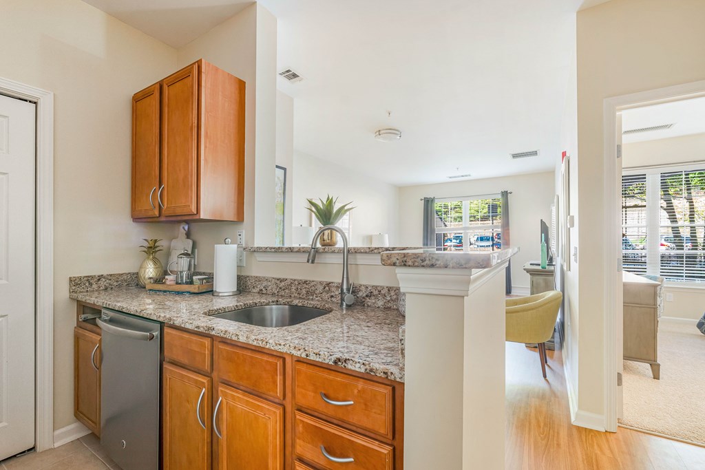 A kitchen with a sink and a refrigerator.