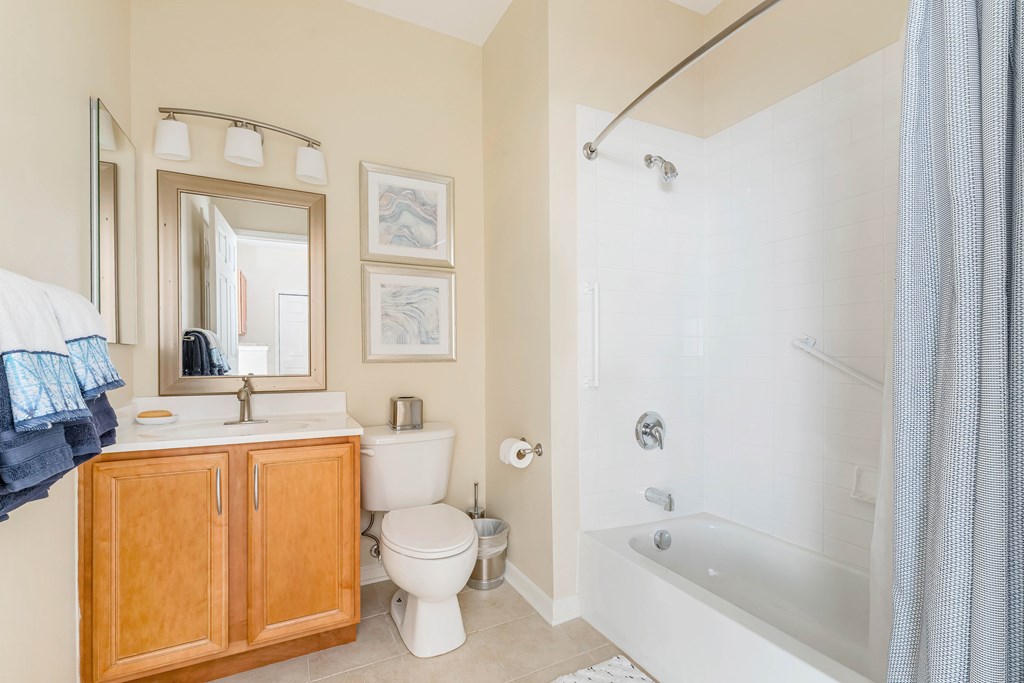 A bathroom with a white tub, toilet, and sink.