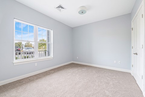 A room with a window and a ceiling fan.