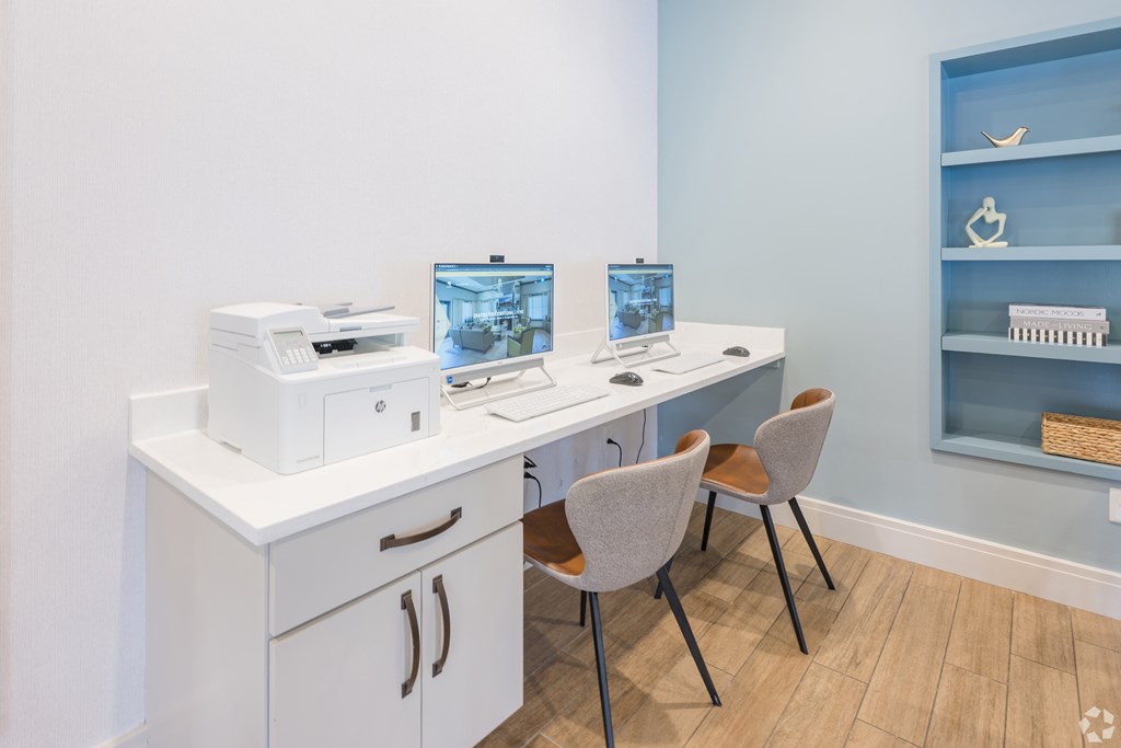 A white desk with a laptop and a printer on it at Axis at Lakeshore Apartments, Bridgewater, Massachusetts, 02324