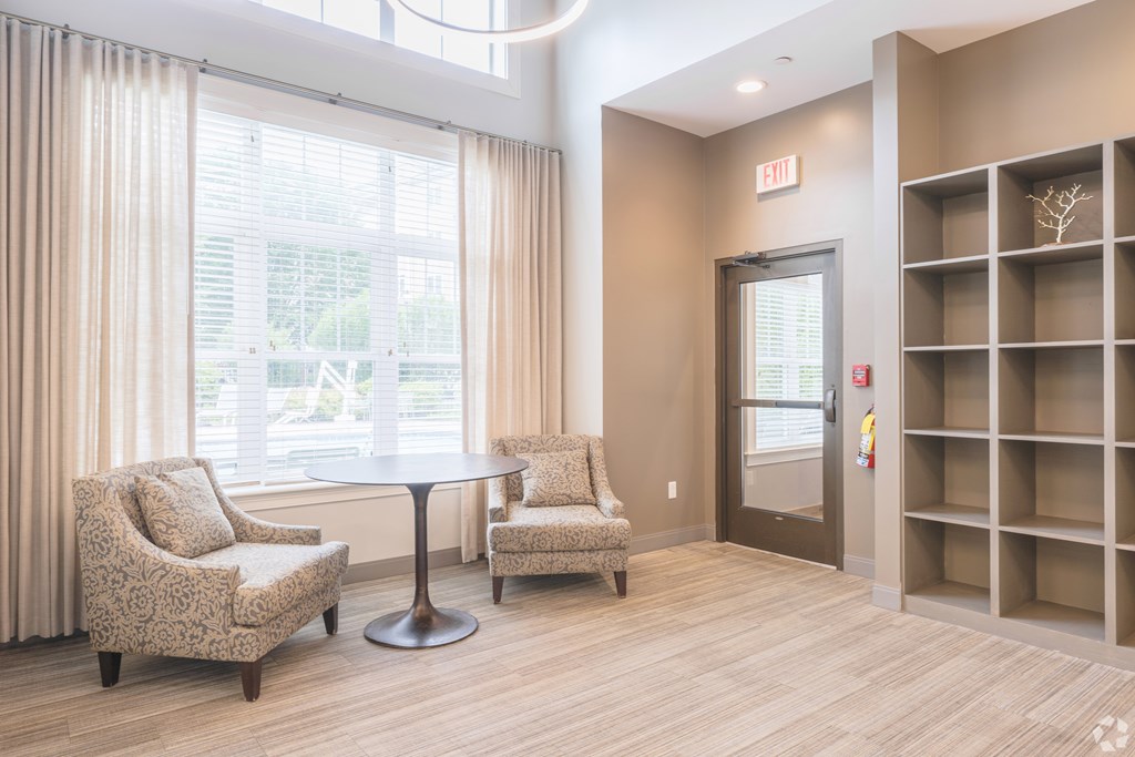 A room with a round table and two chairs with a window behind them at Axis at Lakeshore Apartments, Bridgewater, Massachusetts