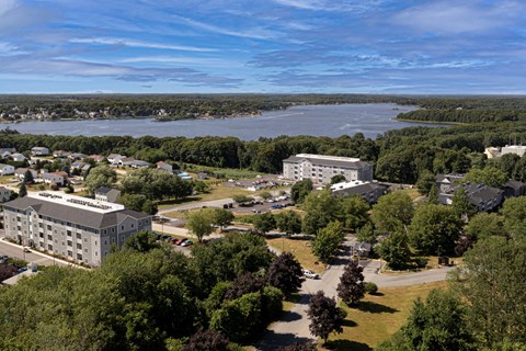 an aerial view of a city with a river and buildings