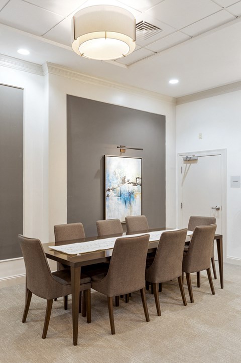 a dining room with a long table and chairs