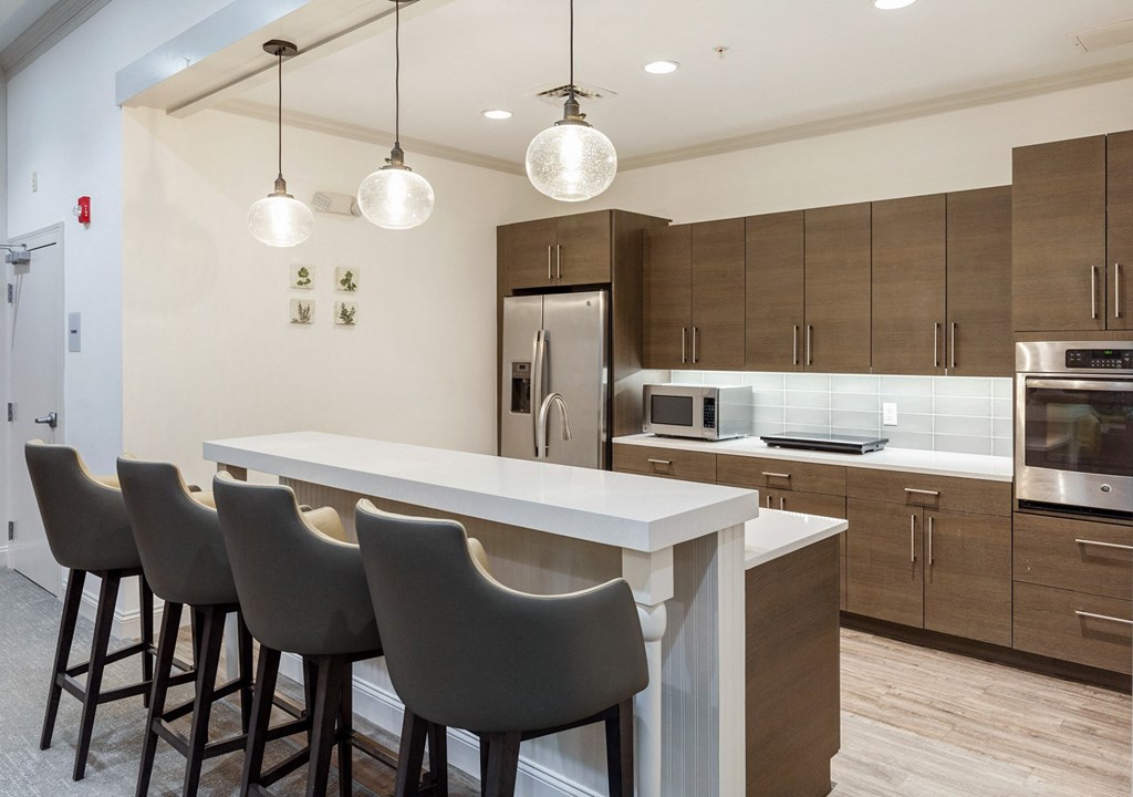 a kitchen with a large island and chairs