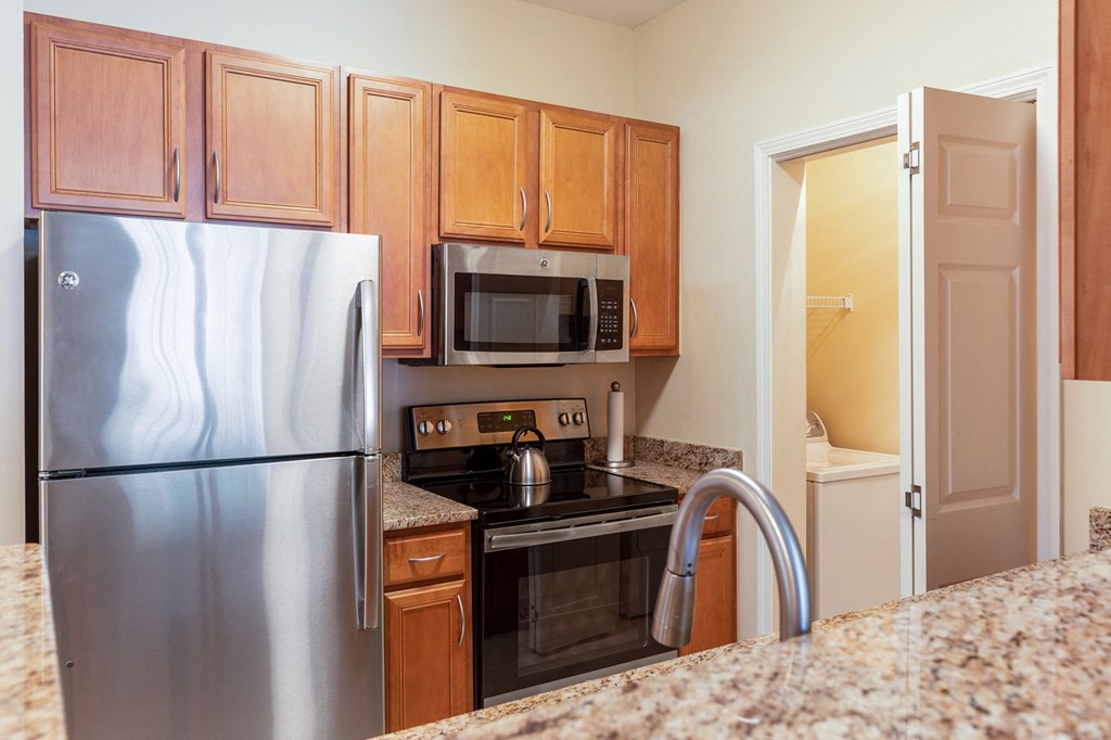 a kitchen with stainless steel appliances and granite counter tops