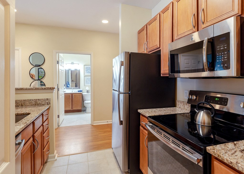 a kitchen with stainless steel appliances and wooden cabinets