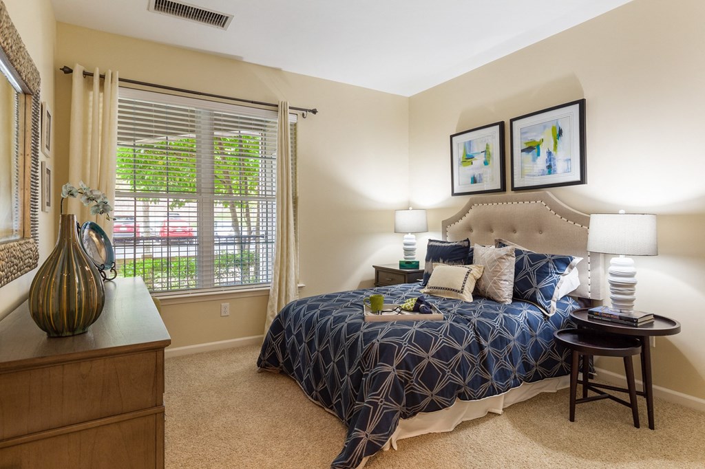 a bedroom with a large bed and a window