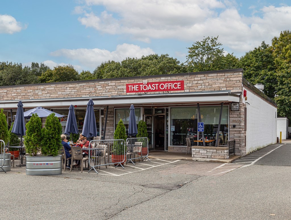 the toasted office restaurant and coffee shop on the side of a parking lot