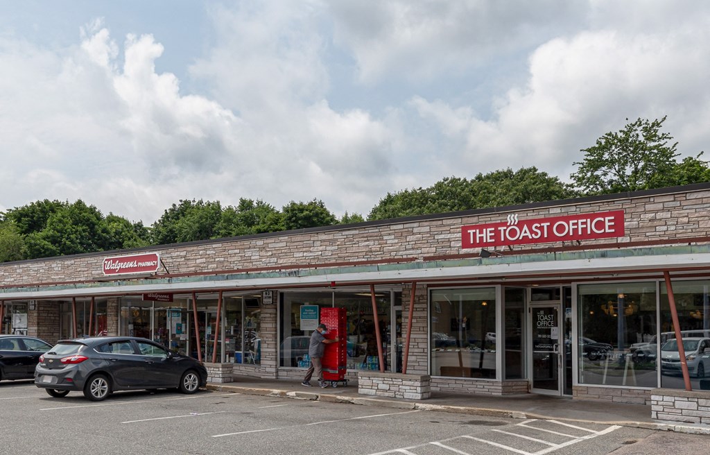 the toasted coffee shop with cars parked in front of it