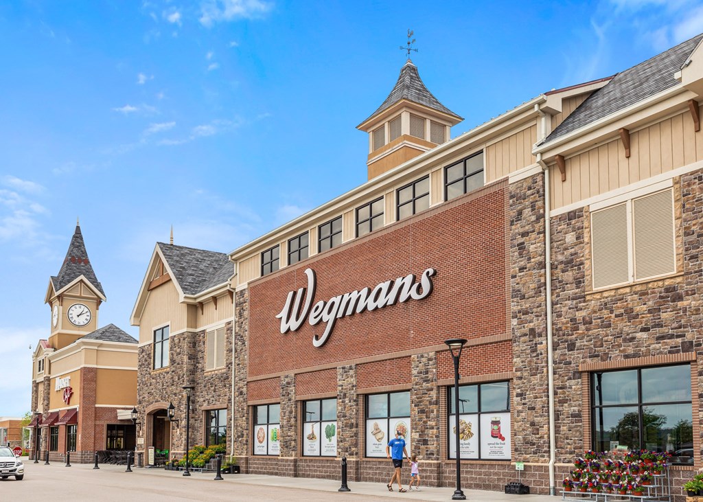 the facade of a store with a clock tower