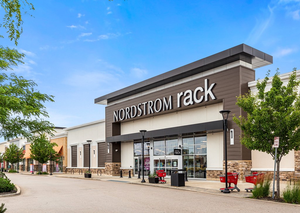 the exterior of a norton rack store with a blue sky in the background