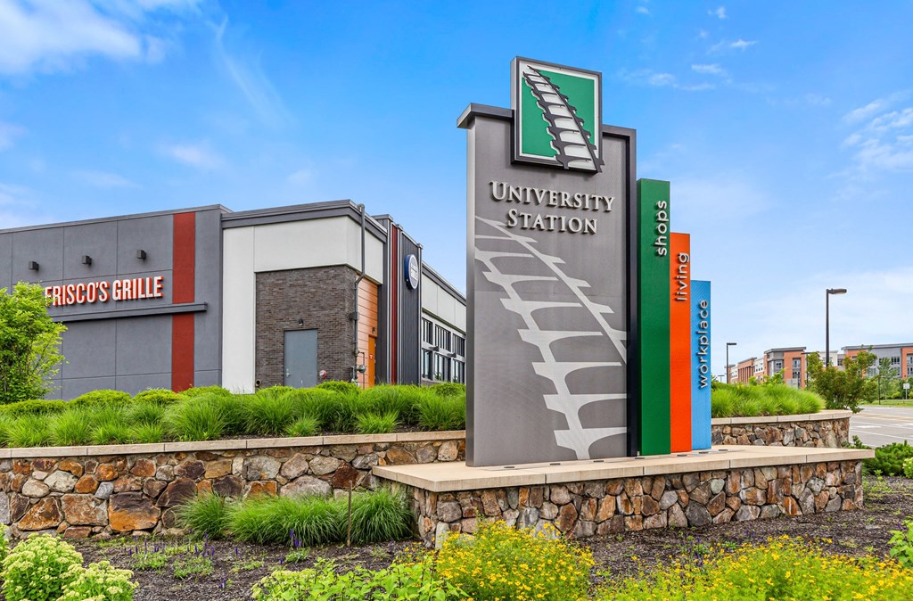 a university station building with a sign in front of it