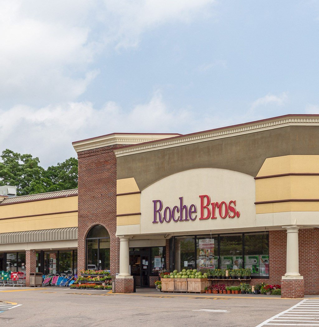 a rocket bros store in a parking lot with a blue sky