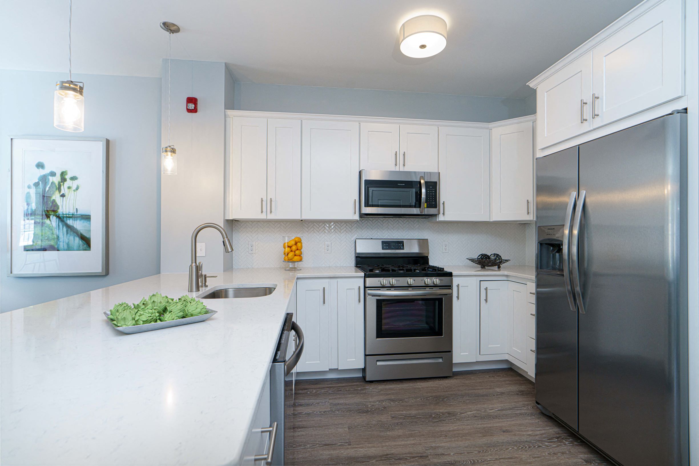 a kitchen with stainless steel appliances and white cabinets