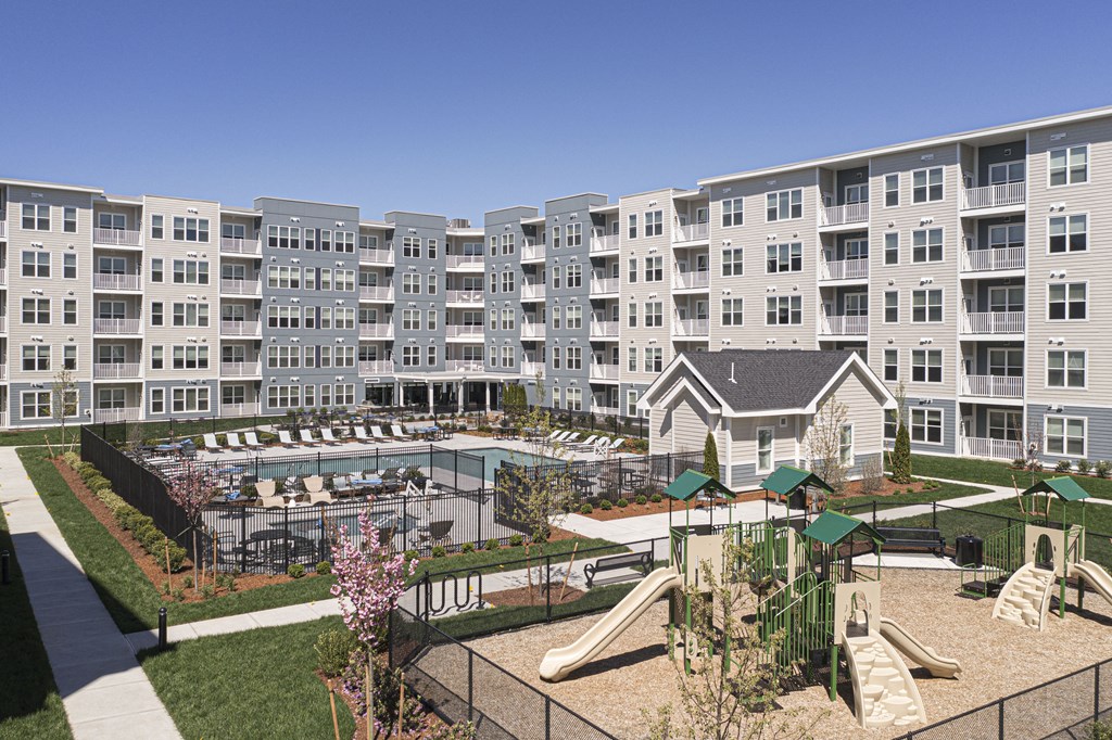 an architectural rendering of an apartment building with a playground