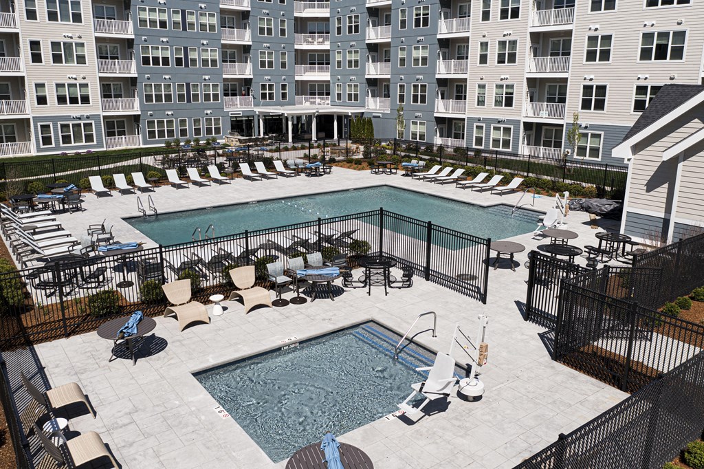 an aerial view of an apartment building with a swimming pool