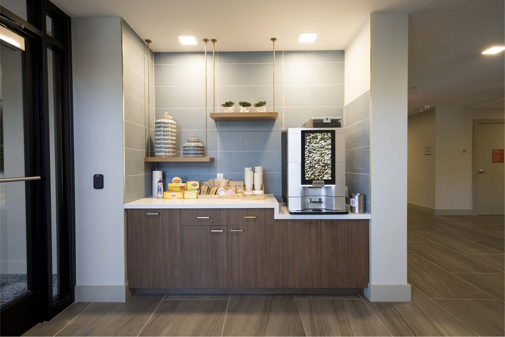 a kitchen with a sink and a coffee maker on the counter