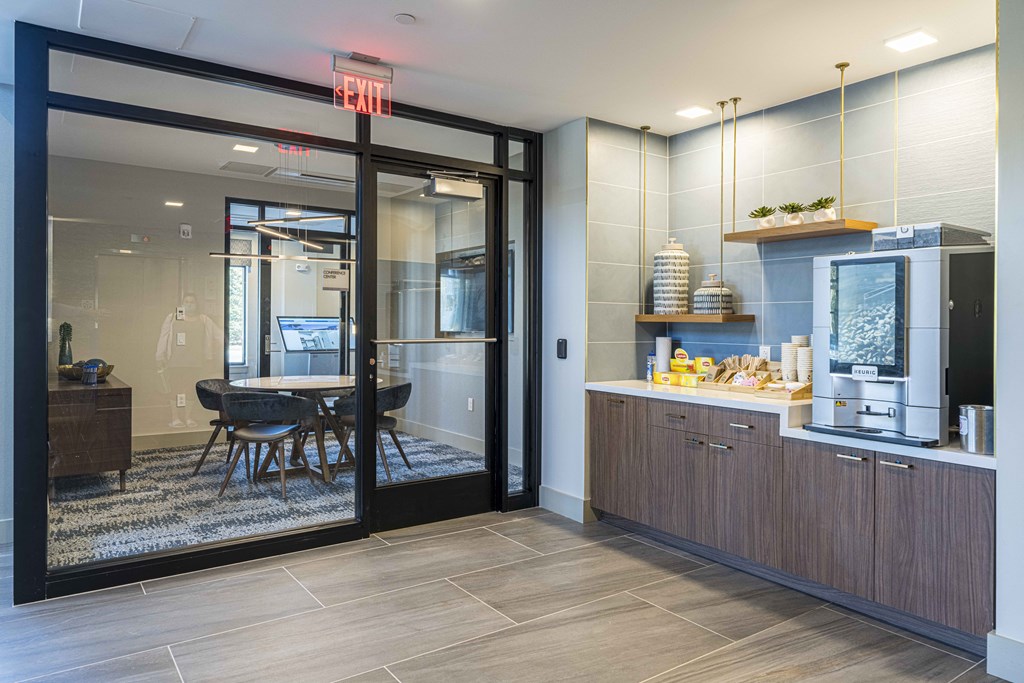a kitchen and dining area in a room with a glass door