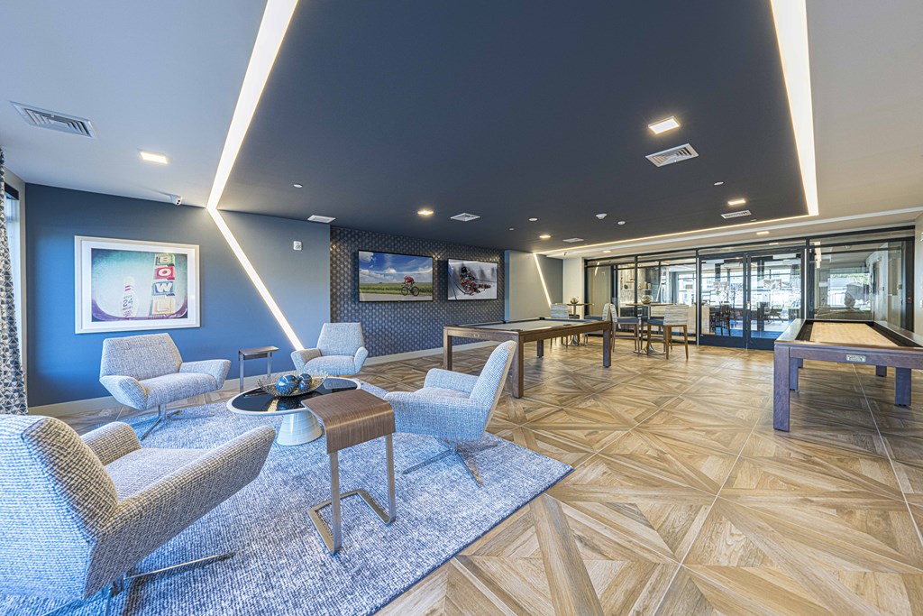 a communal area with chairs and tables in a lobby of a building