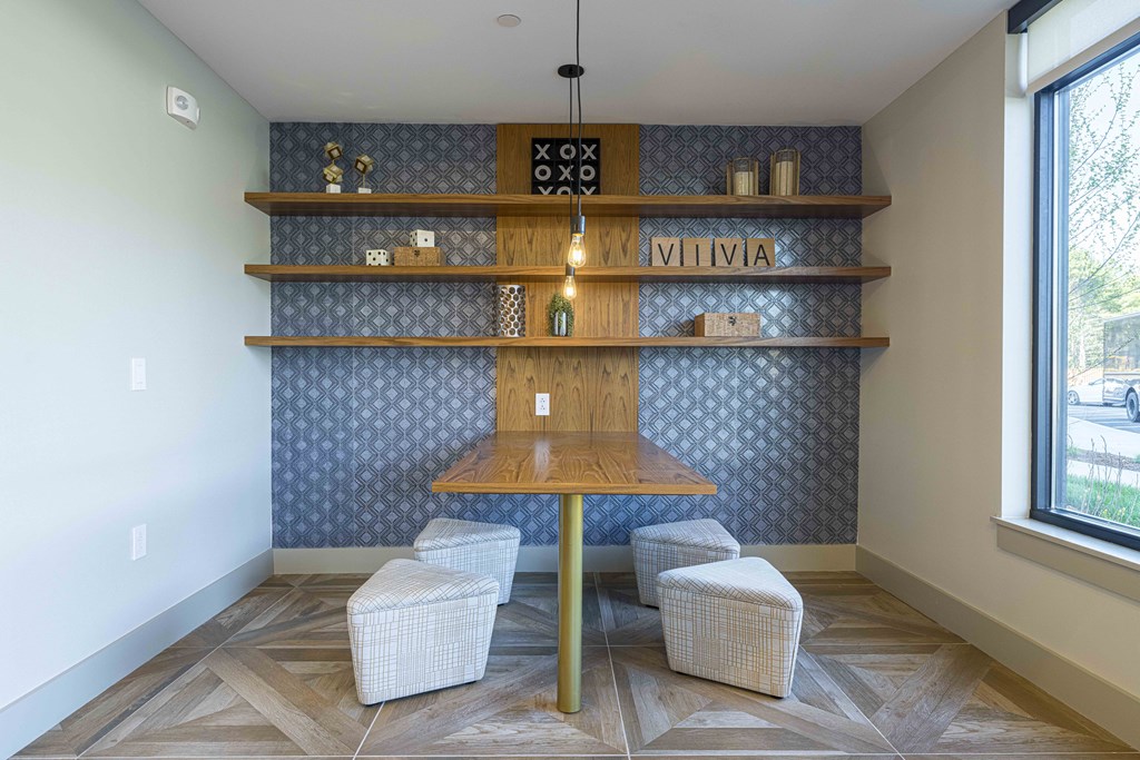 a tasting room with a wooden table and three stools