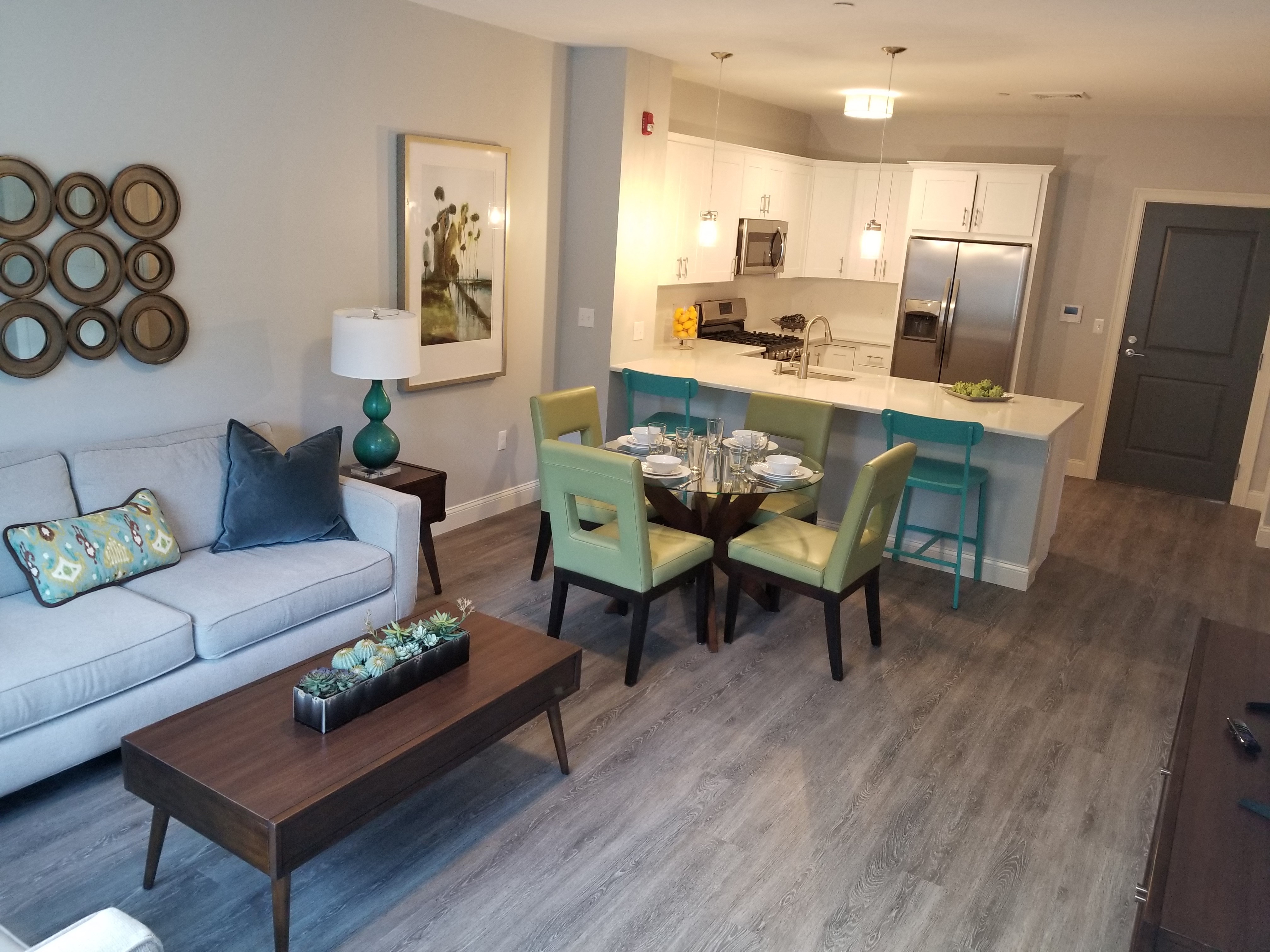 a living room and kitchen with a couch and a table