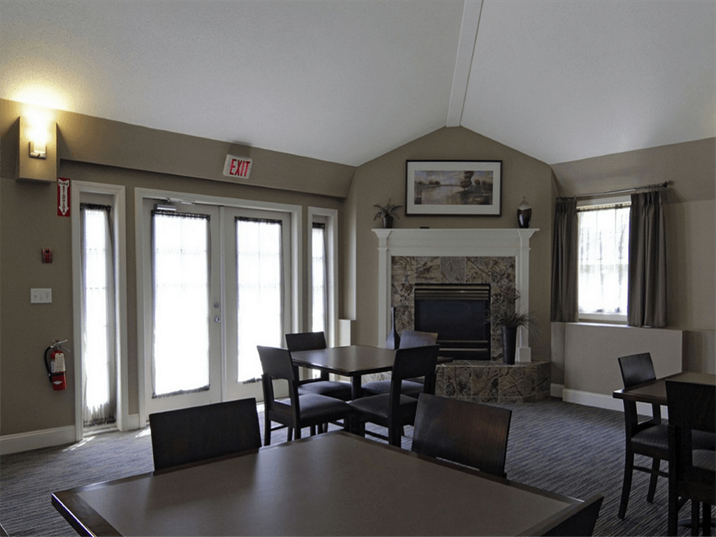 a living room with a table and chairs and a fireplace