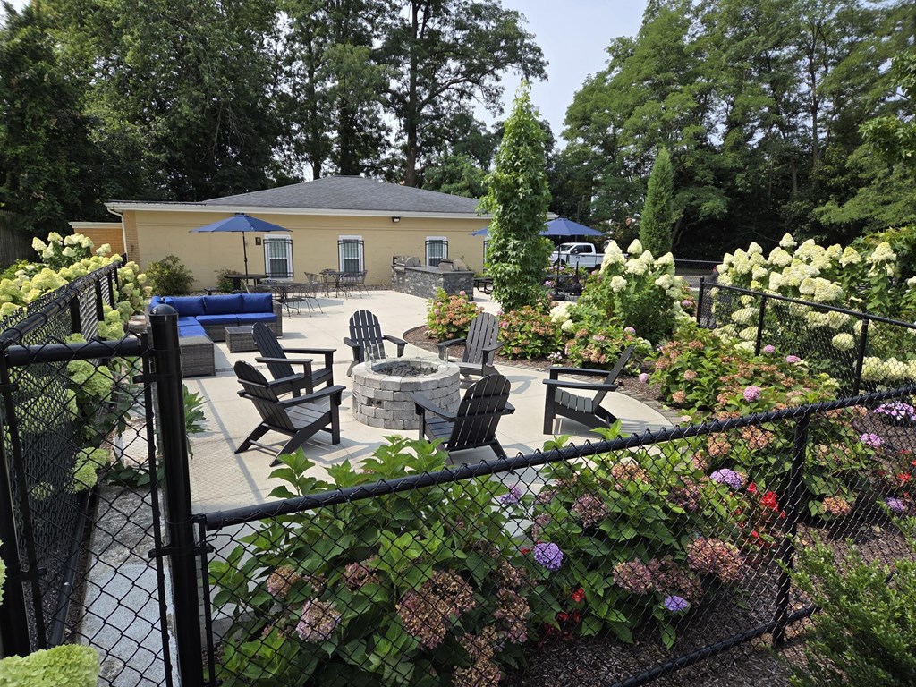 A backyard with a fire pit and seating area.
