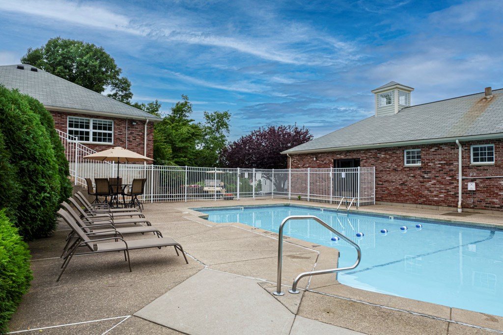 our apartments have a pool and a patio with chairs
