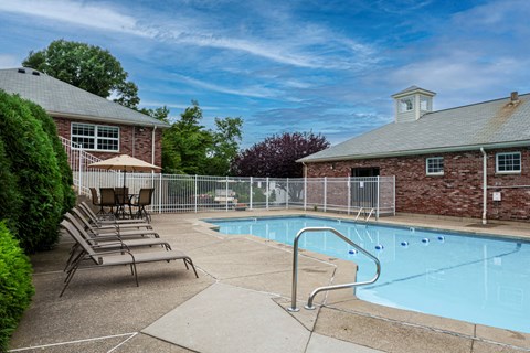 our apartments have a pool and a patio with chairs