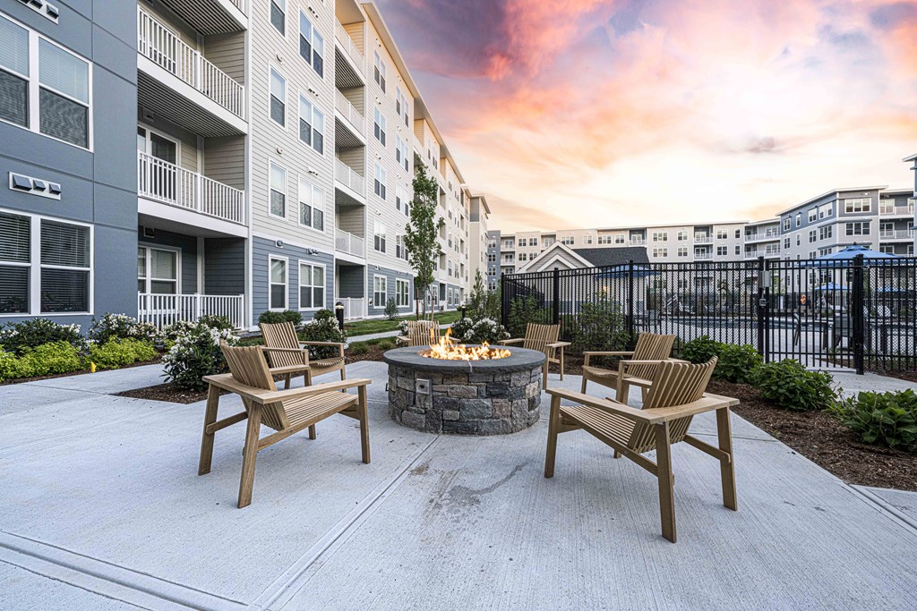 an outdoor patio with a fire pit at an apartment building