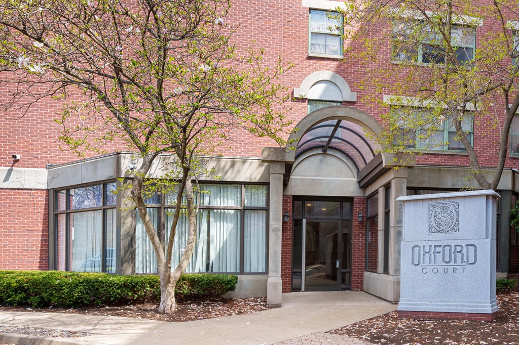 a brick building with a tree in front of it