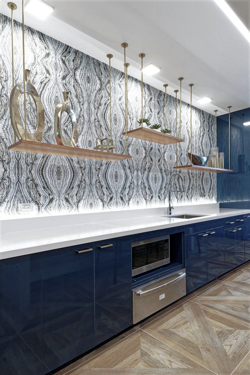 a kitchen with blue cabinets and a white counter top