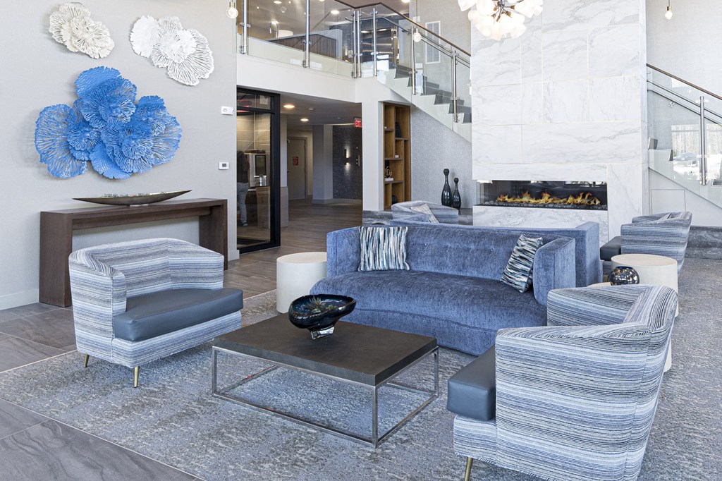 a living room with blue and white furniture and a fireplace