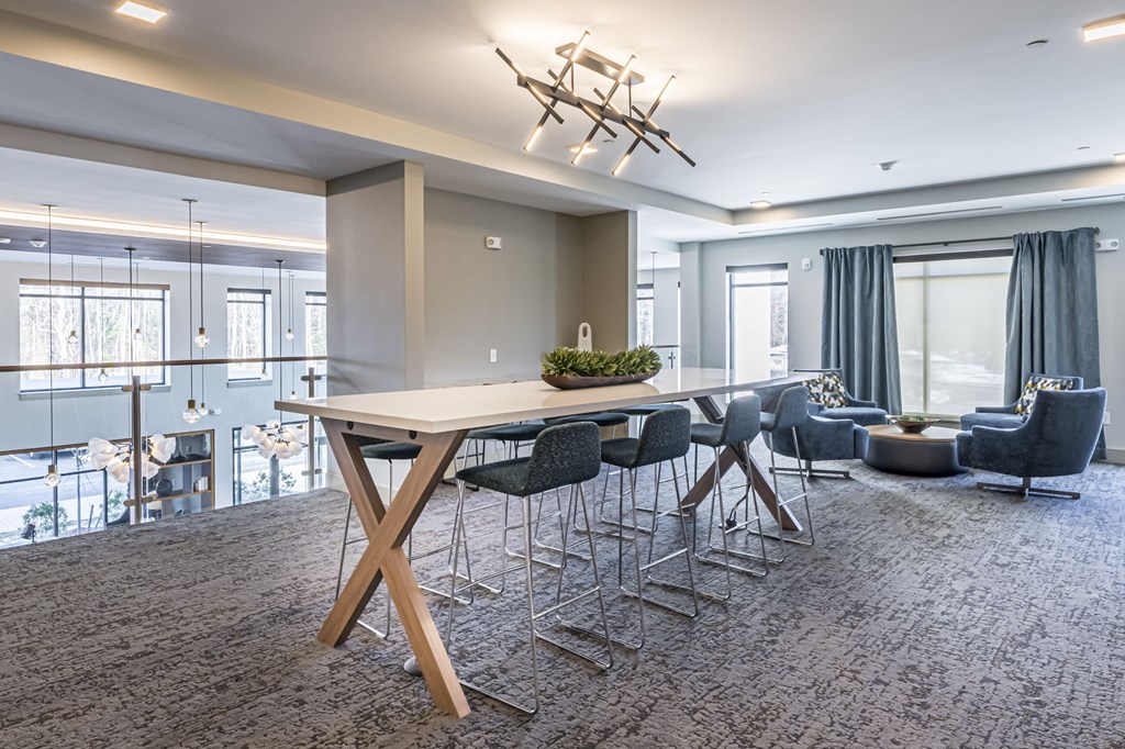 a dining room with a large table and chairs