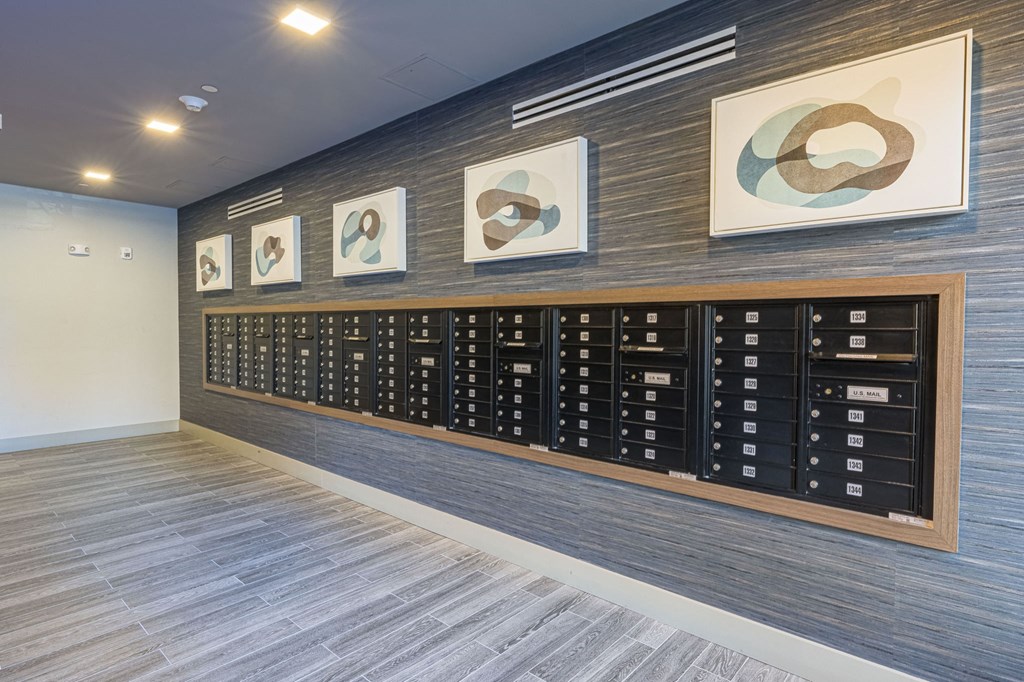 a filing cabinet in a room with paintings on the wall