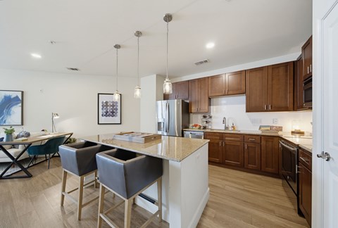 A kitchen with brown cabinets and a white island.
