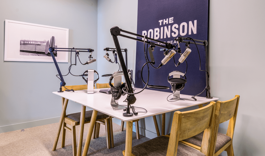 A studio setup with a microphone and headphones on a table.