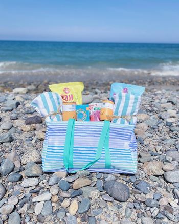 a spa bag on a beach with the ocean in the background