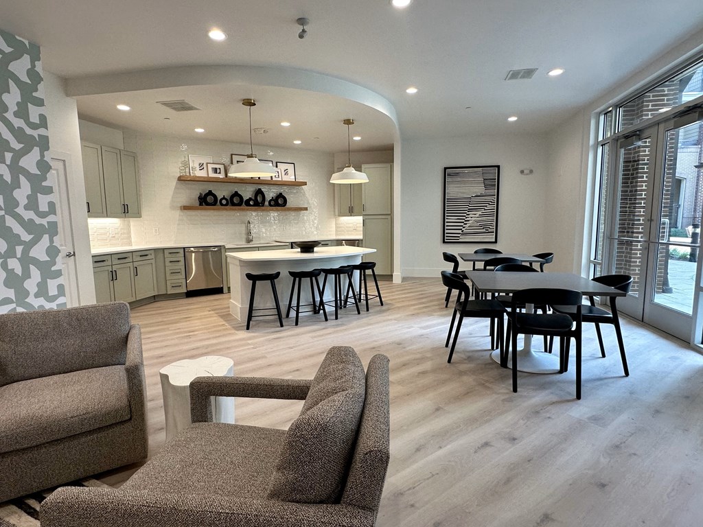 a kitchen and living room with a table and chairs