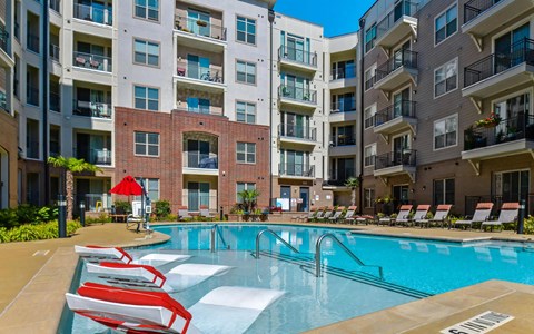 Refreshing Pool with Walk-In Entry and Loungers at The Maggie