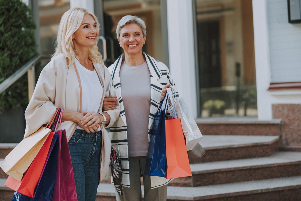 two women walking down the steps with shopping bags