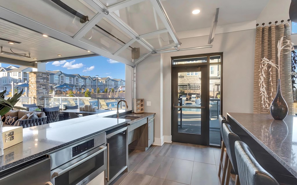 Lounge with Garage Door Opening to Outdoor Patio