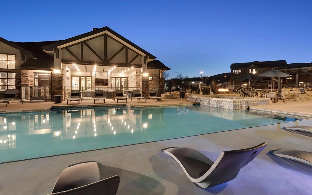 Outdoor Pool with Chaise Loungers at Dusk