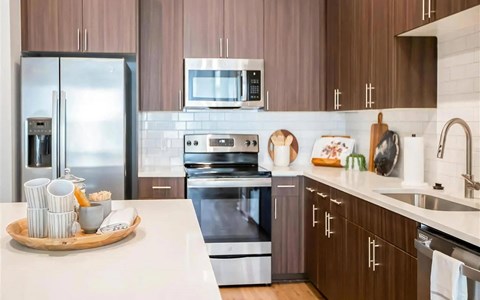 a kitchen with stainless steel appliances and wooden cabinets