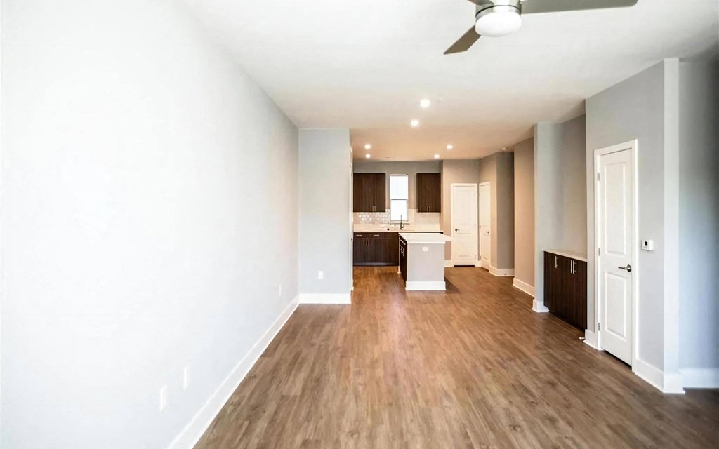 Open concept layout with wood-inspired flooring