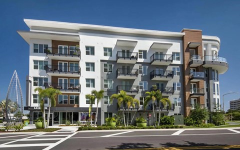 Anchor Riverwalk Building Exterior with Modern Balconies, Palm Trees, and Leasing Office