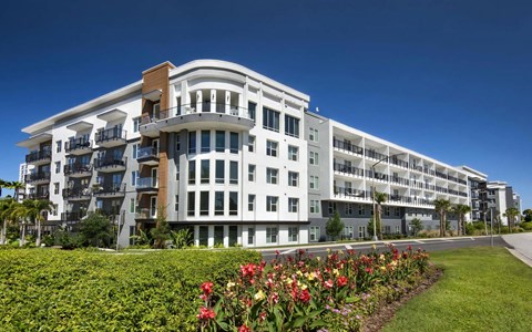 Anchor Riverwalk Apartment Community with Landscaped Grounds and Corner Window Design