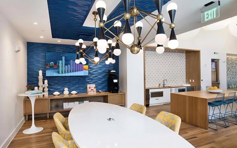 Community Lounge with TV, Coffee Station, and Modern Lighting Fixtures